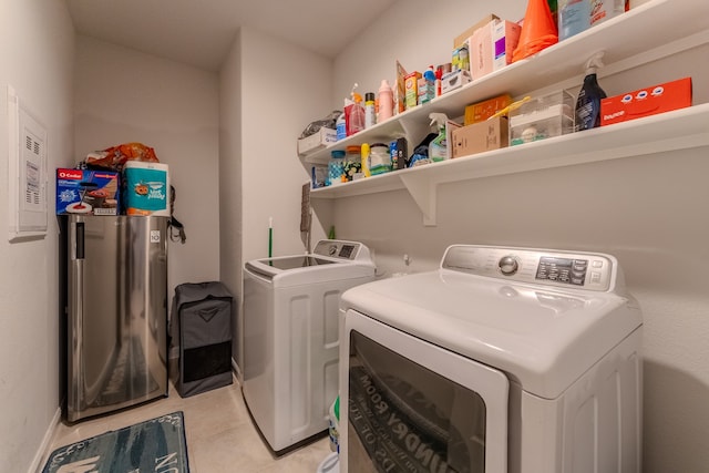 laundry room with light tile patterned flooring and independent washer and dryer