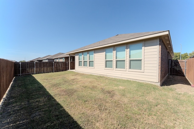 back of property featuring a yard