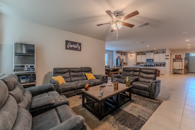 living room featuring ceiling fan and light tile patterned flooring