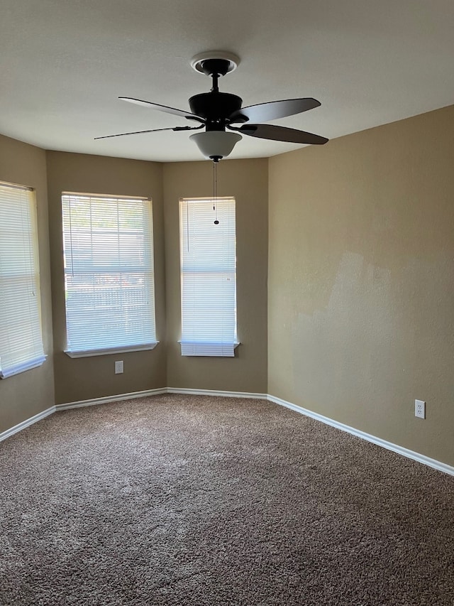 carpeted spare room with ceiling fan