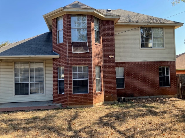 rear view of house with a lawn