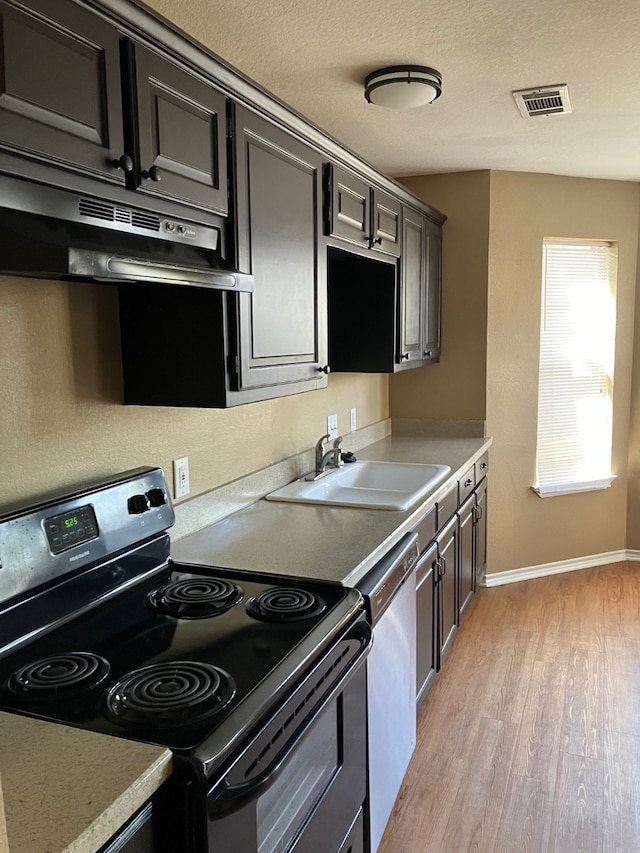 kitchen with black range with electric cooktop, sink, light hardwood / wood-style floors, dishwashing machine, and range hood