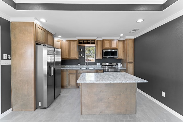 kitchen featuring crown molding, sink, a kitchen island, stainless steel appliances, and light stone counters