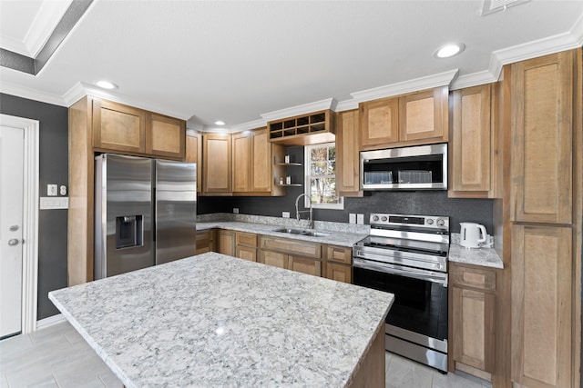 kitchen with appliances with stainless steel finishes, sink, a kitchen island, light stone counters, and ornamental molding