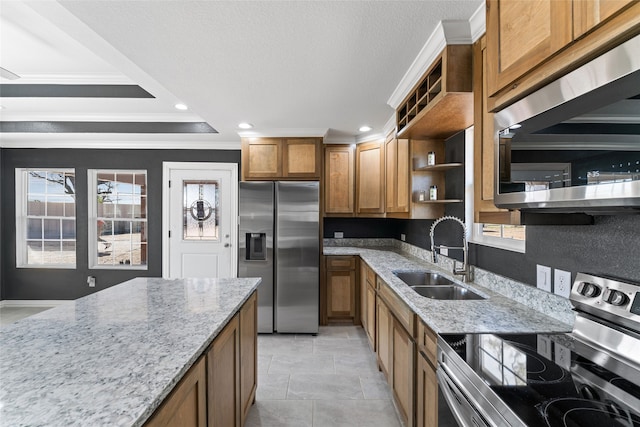 kitchen featuring crown molding, appliances with stainless steel finishes, sink, light stone counters, and light tile patterned floors