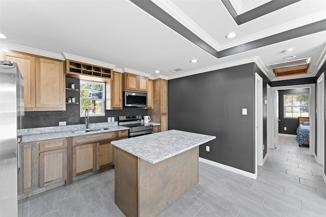 kitchen featuring sink, stainless steel appliances, a center island, and a healthy amount of sunlight