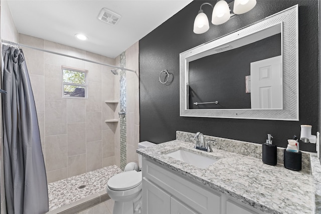 bathroom featuring toilet, a shower with curtain, vanity, and tile patterned flooring