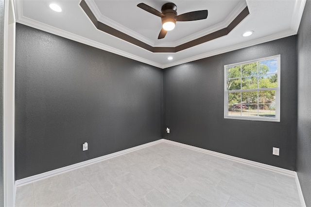 spare room featuring ornamental molding, a raised ceiling, and ceiling fan