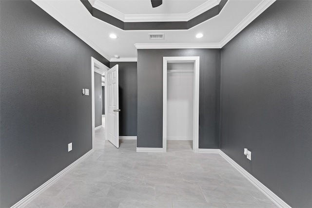 unfurnished bedroom featuring a closet, crown molding, and ceiling fan