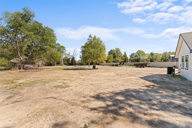 view of yard featuring cooling unit and a rural view