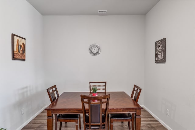 dining area featuring dark wood-type flooring