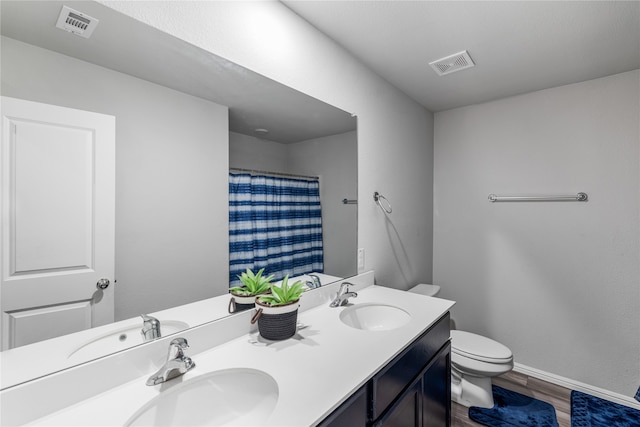 bathroom with vanity, hardwood / wood-style floors, a shower with shower curtain, and toilet