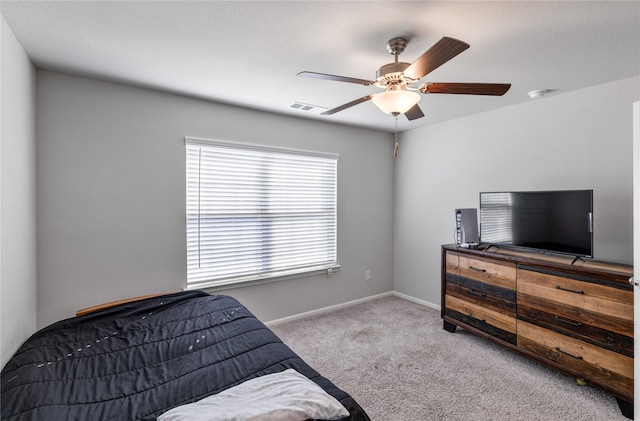 bedroom featuring light colored carpet and ceiling fan