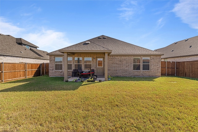 rear view of house featuring a patio area and a lawn