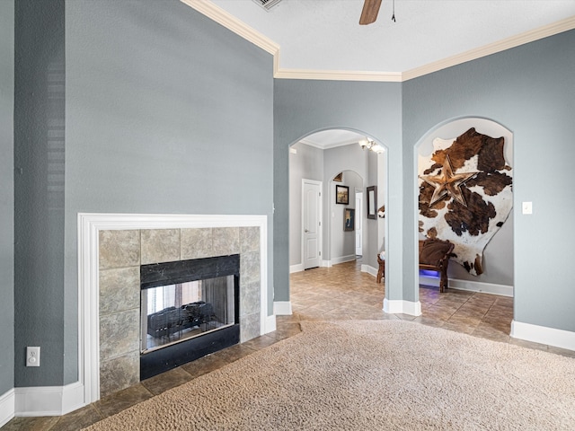 living room with ceiling fan, a fireplace, and ornamental molding