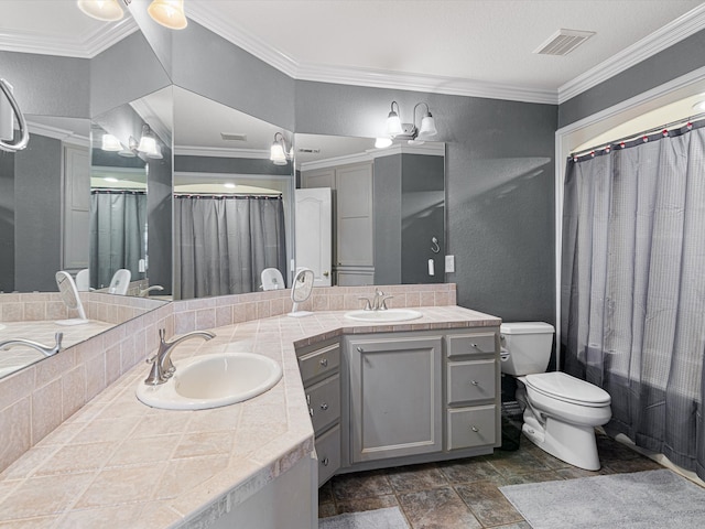 bathroom with vanity, toilet, a bathtub, and ornamental molding