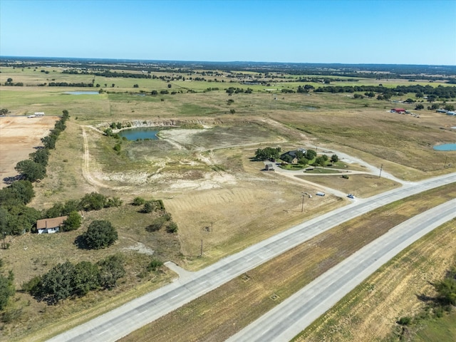 birds eye view of property with a rural view and a water view