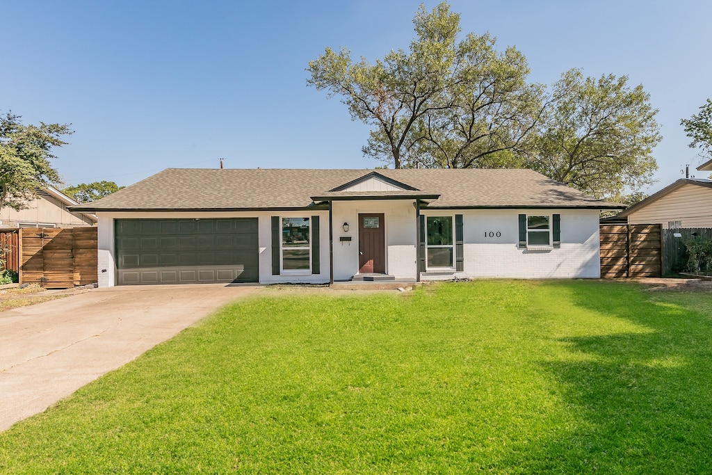 ranch-style home with a front yard and a garage