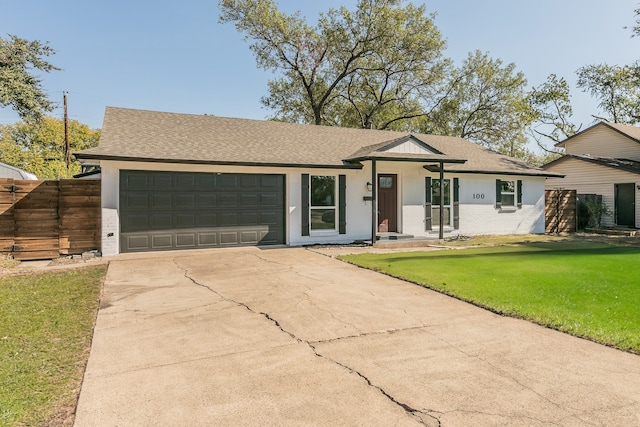 ranch-style home featuring a front yard and a garage