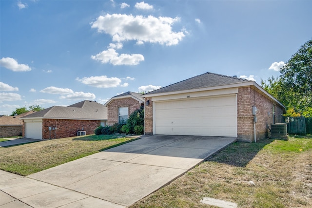 ranch-style house with a garage, a front lawn, and central AC unit