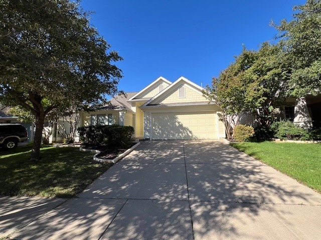 view of front of property featuring a front lawn and a garage