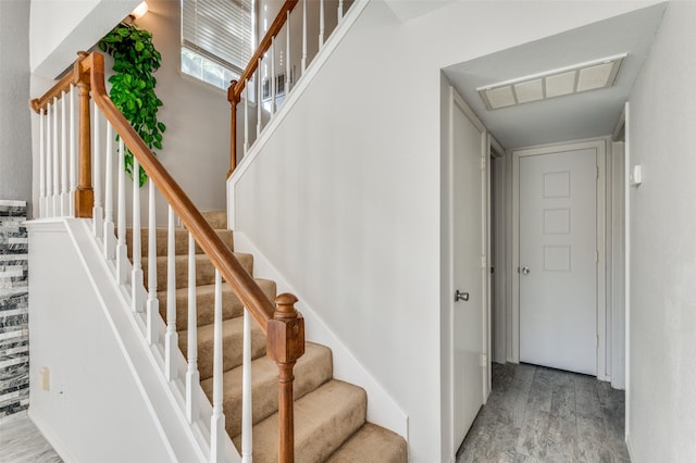 staircase featuring wood-type flooring