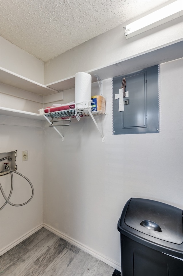 interior space featuring washer hookup, a textured ceiling, and hardwood / wood-style flooring