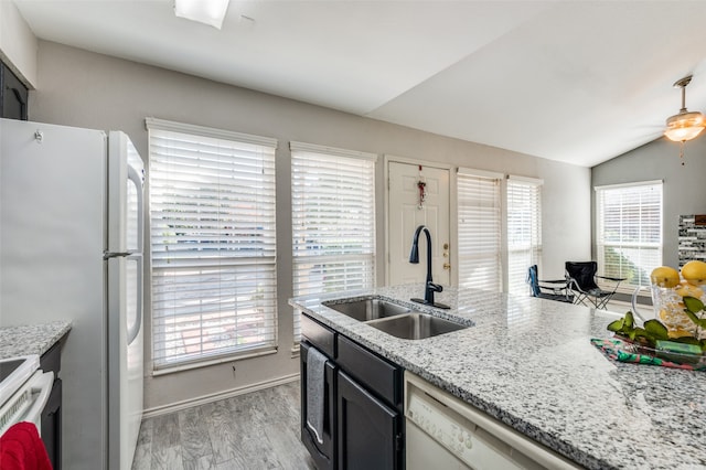 kitchen featuring plenty of natural light, light wood-type flooring, sink, and vaulted ceiling