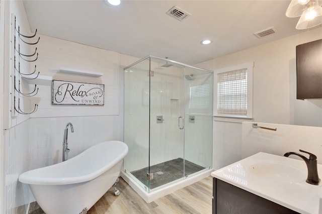 bathroom with vanity, tile walls, shower with separate bathtub, and hardwood / wood-style floors