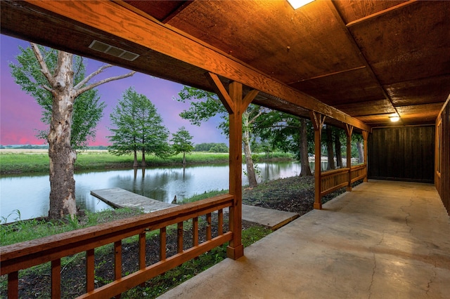 view of dock featuring a patio and a water view