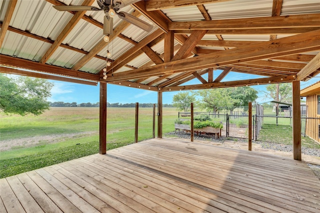 wooden terrace with a rural view and a yard