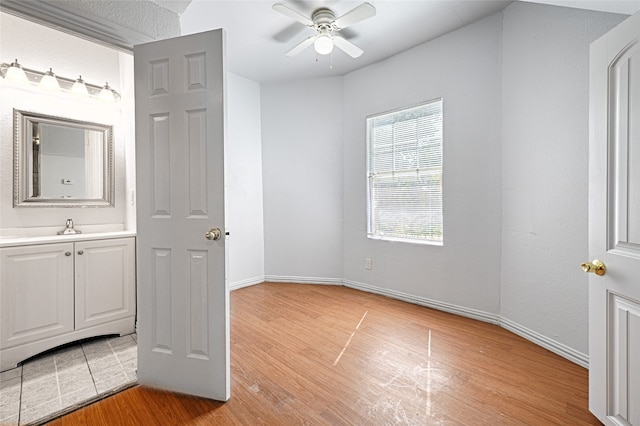 bathroom featuring vanity, a textured ceiling, wood-type flooring, and ceiling fan