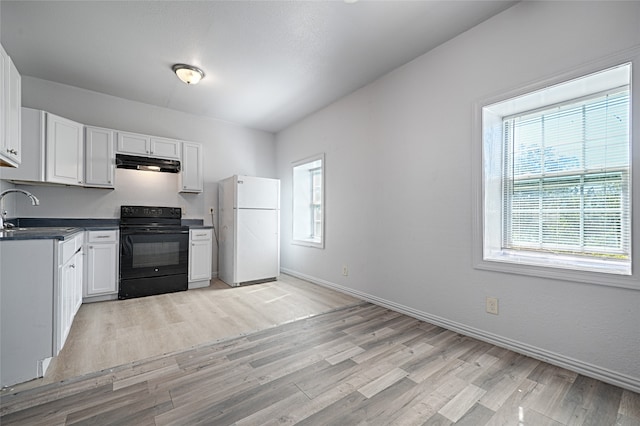 kitchen with black electric range oven, white cabinetry, light hardwood / wood-style flooring, white fridge, and sink