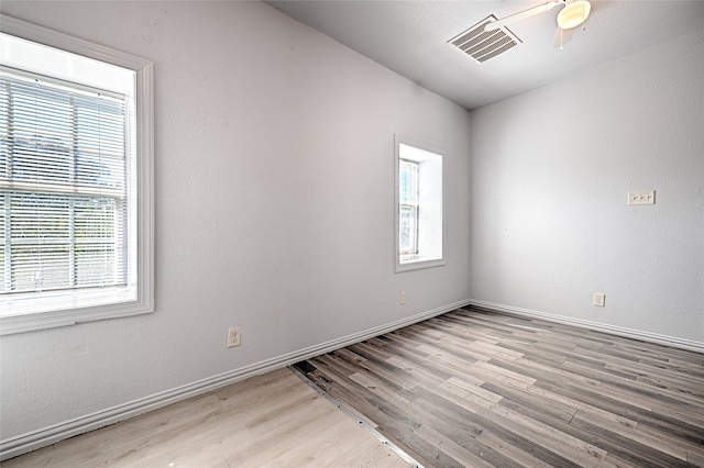 spare room featuring light hardwood / wood-style flooring and ceiling fan