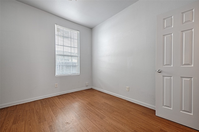 spare room with wood-type flooring