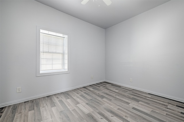 empty room featuring light wood-type flooring and ceiling fan