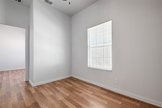 spare room with ceiling fan and light wood-type flooring