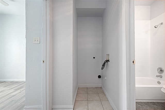 bathroom with hardwood / wood-style floors, ceiling fan, and shower / bath combination