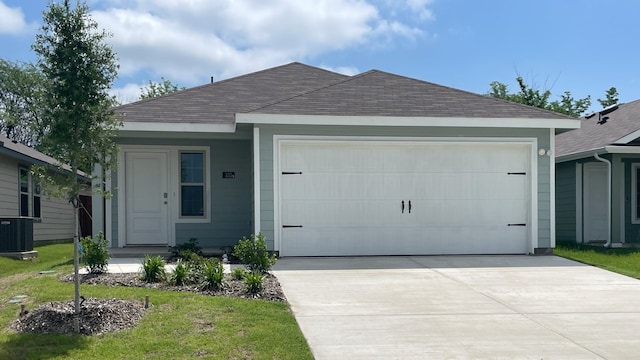 single story home with a front yard and a garage