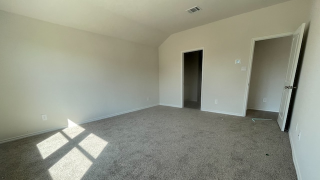 unfurnished bedroom featuring light carpet and lofted ceiling