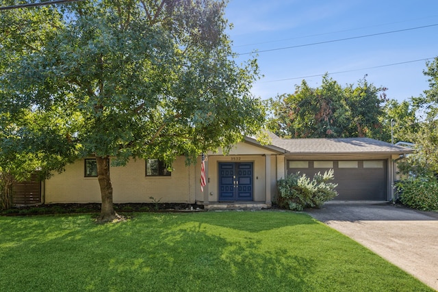 view of front of home featuring french doors, a front lawn, and a garage