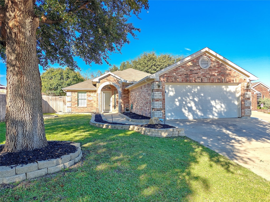 single story home featuring a garage and a front lawn