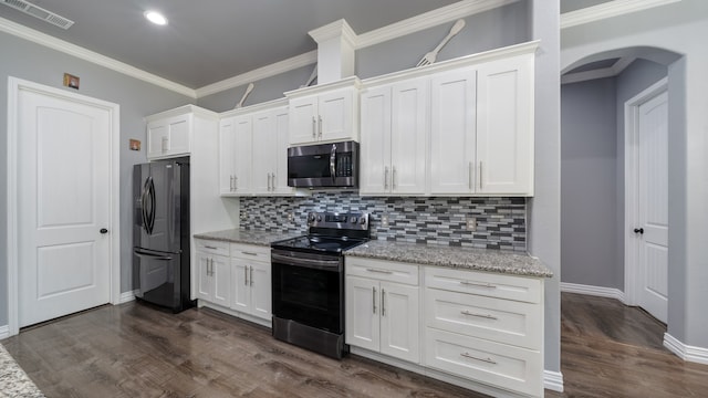 kitchen with appliances with stainless steel finishes, light stone counters, dark hardwood / wood-style floors, and white cabinetry