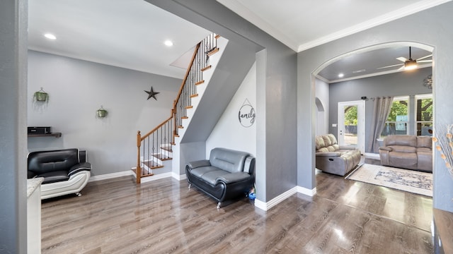 interior space featuring ceiling fan, hardwood / wood-style flooring, and crown molding