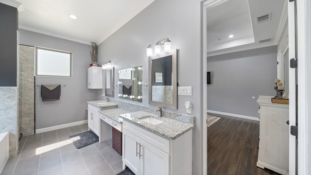 bathroom featuring vanity, ornamental molding, walk in shower, and tile patterned flooring