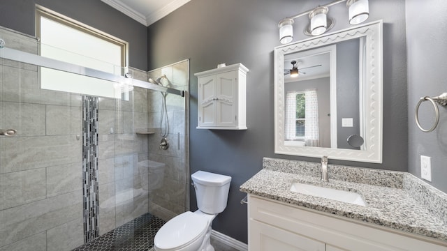 bathroom featuring ceiling fan, toilet, ornamental molding, a shower with shower door, and vanity