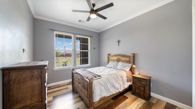 bedroom featuring ceiling fan, crown molding, and hardwood / wood-style floors