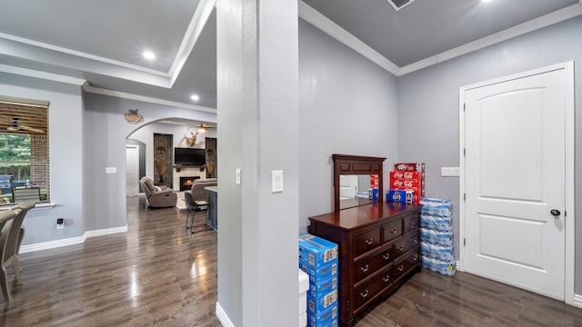 corridor featuring ornamental molding and dark hardwood / wood-style flooring