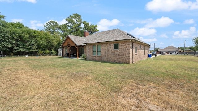 back of property featuring a lawn