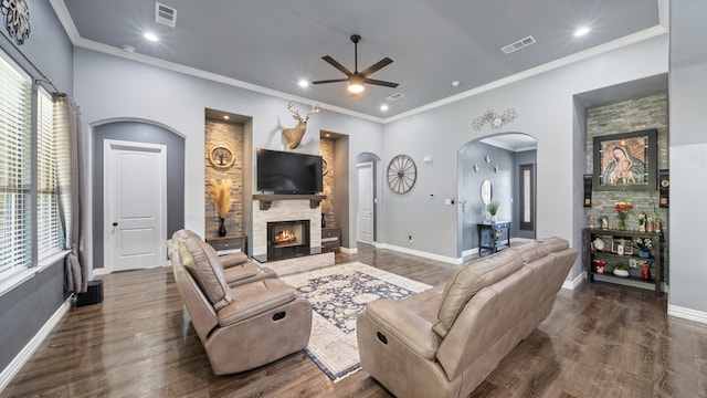 living room with a healthy amount of sunlight, a fireplace, and dark hardwood / wood-style floors